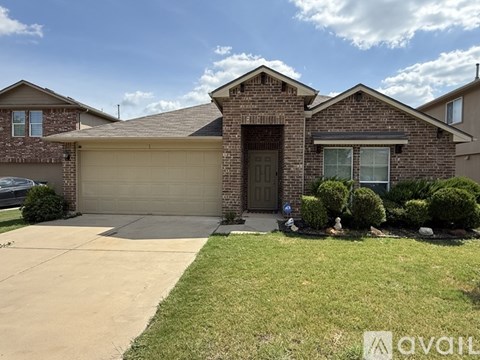A house with a garage and a driveway in front.