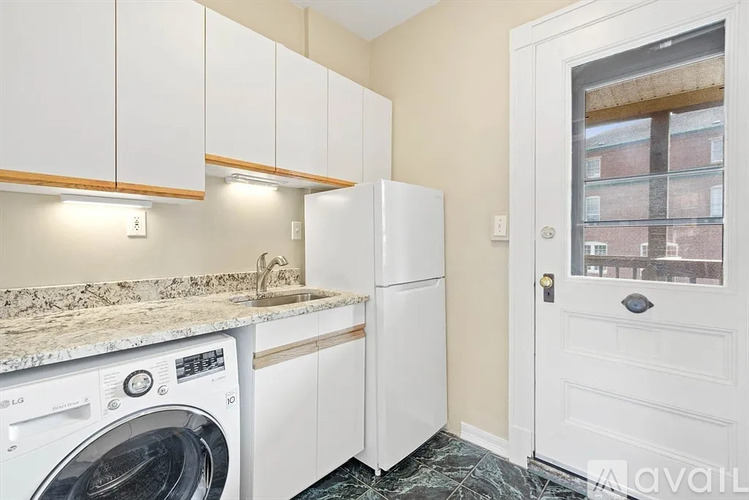 A small laundry room with a washer and dryer.