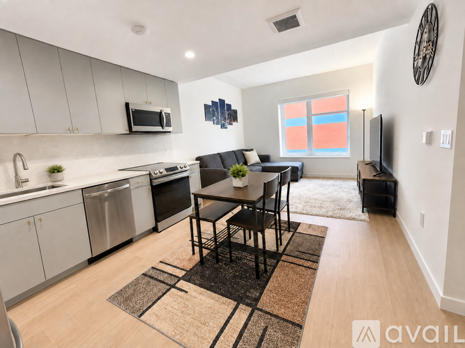 A kitchen with a dining table and chairs in the middle of the room.