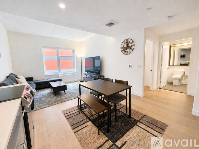 A living room with a black table and a television.