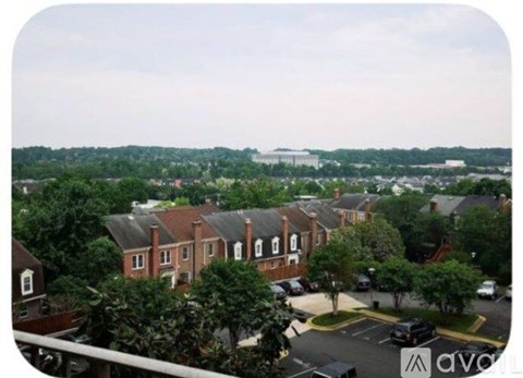 A view of a residential area with houses and a parking lot.