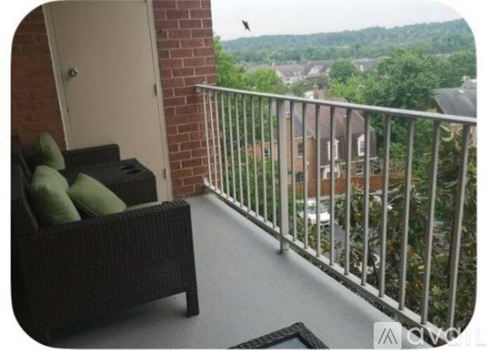 A balcony with a chair and a table.