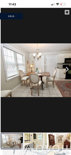 A dining room with a table set for four.