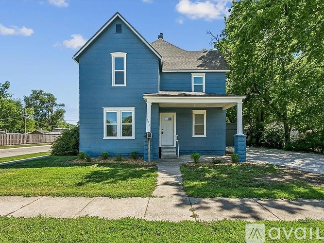 A blue house with a white door and windows.