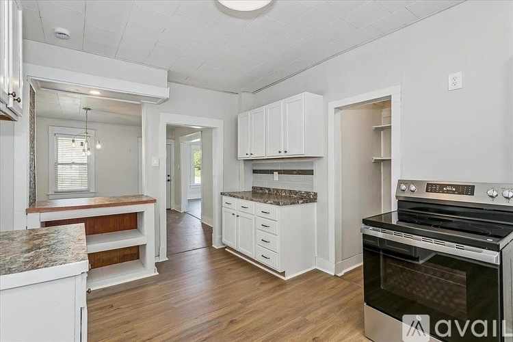A kitchen with a stove top oven and a counter top.