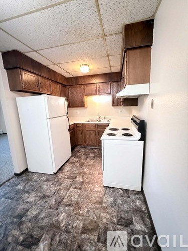 A kitchen with a white fridge and a white stove top oven.