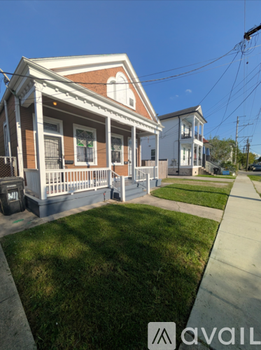 A two-story house with a red and white front porch.