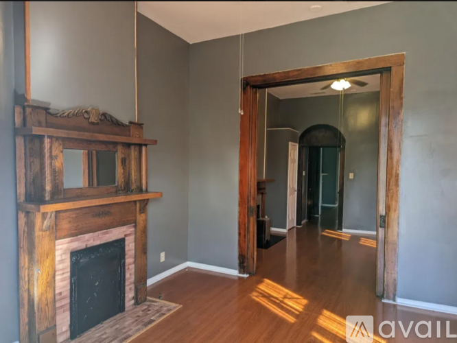 A room with a fireplace and a mirror on the wall.