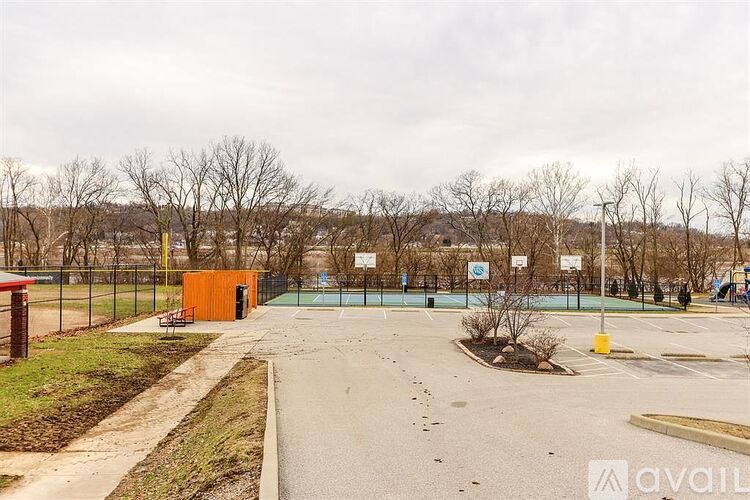 A playground with a basketball court and a slide.