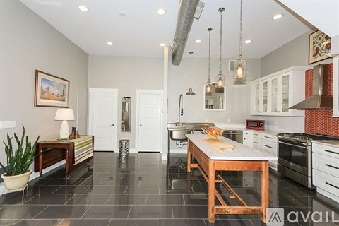 A kitchen with a table and chairs in the middle of the room.