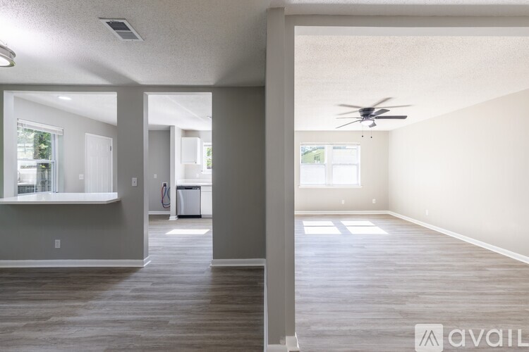 A spacious room with a ceiling fan and a window.