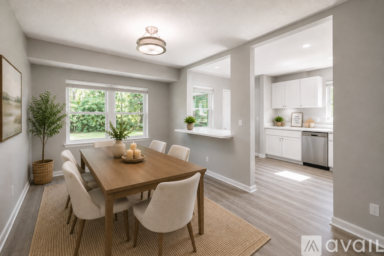 A dining room with a wooden table and chairs.