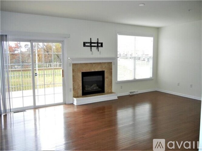 A living room with a fireplace and sliding glass doors.