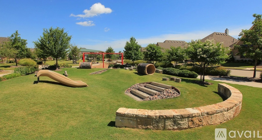 A park with a grassy area, a fire pit, and a sculpture of a banana.