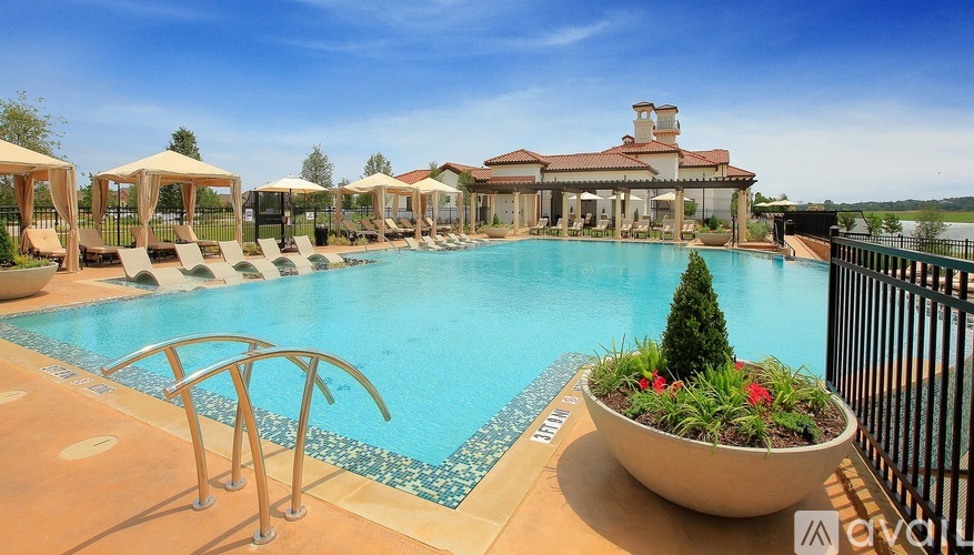 A pool with a slide and a building in the background.