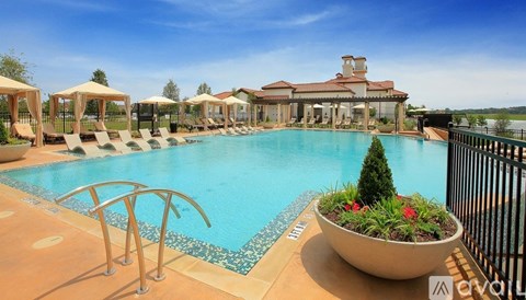 A pool with a slide and a building in the background.