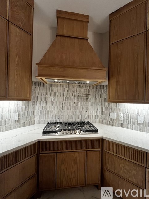 A kitchen with wooden cabinets and a white countertop.