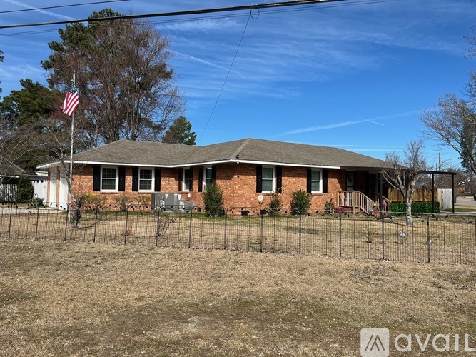 A house with a flag on the front lawn.