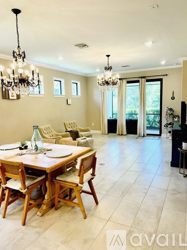 A dining room with a wooden table and chairs.
