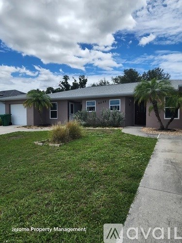 A house with a lawn and a sign that says Jerome Property Management.