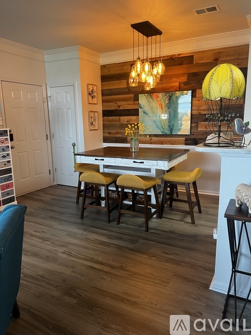 A dining room with a wooden table and chairs.