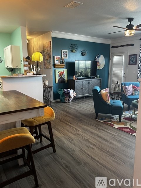 A kitchen with a dining table and chairs.