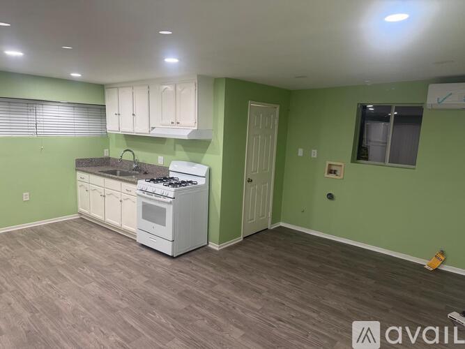 A kitchen with green walls and white appliances.