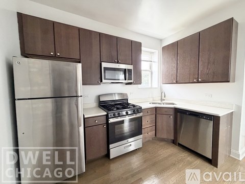 A kitchen with wooden cabinets and stainless steel appliances.