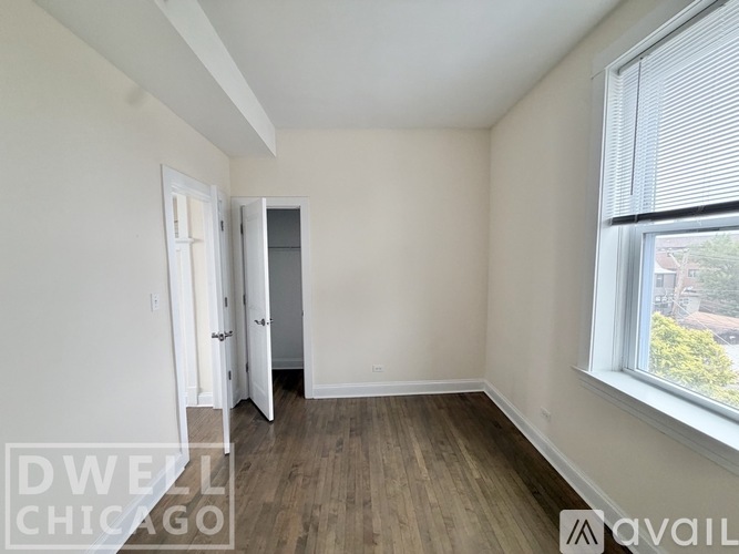 A room with a window and a door is available for rent.