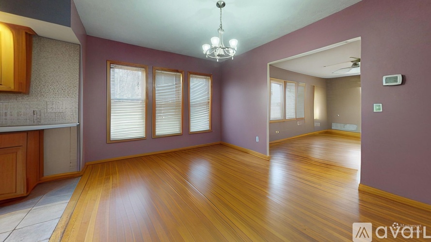 A room with wooden floors and a chandelier.
