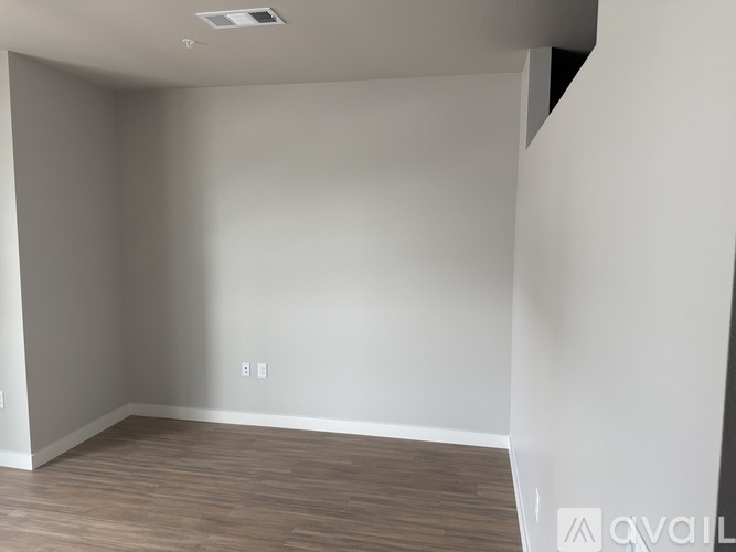 A room with a wooden floor and white walls.