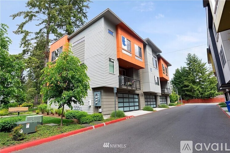 A modern two-story apartment building with a red and grey exterior.