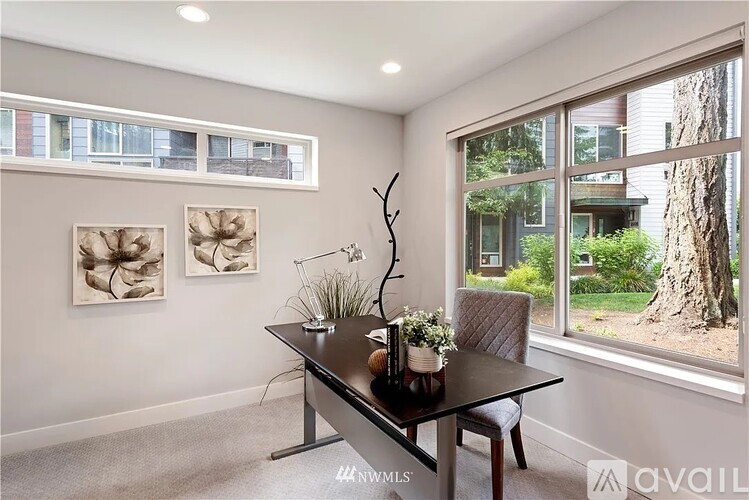 A modern dining room with a glass table and chairs.