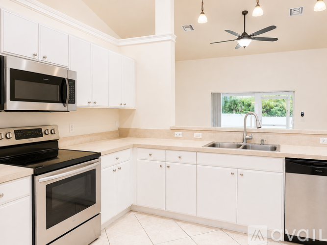 A kitchen with white cabinets and stainless steel appliances.
