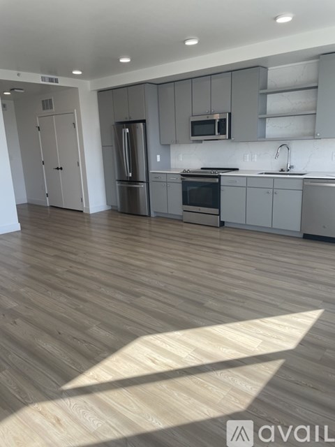 A kitchen with wooden floors and modern appliances.