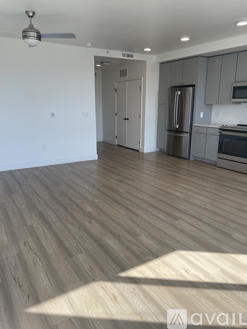 A spacious kitchen with a refrigerator, microwave, and oven.