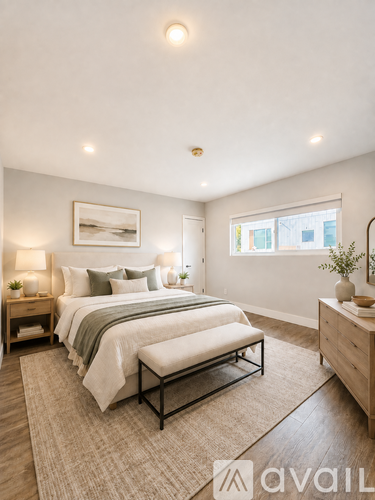 A bedroom with a large bed and a bench in front of it.