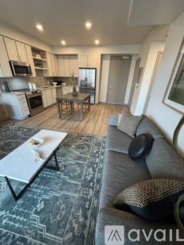 A modern living room with a grey sofa and a coffee table.