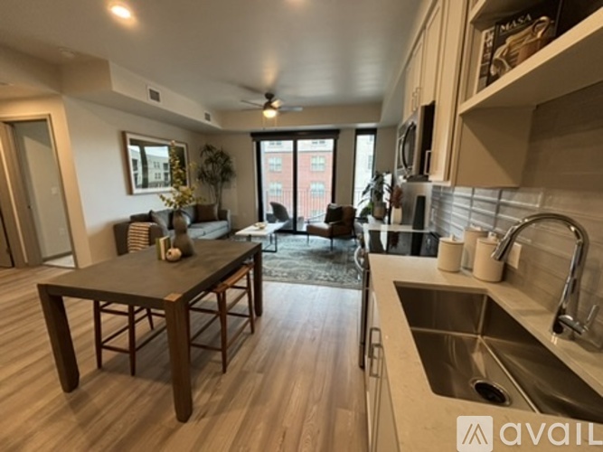 A kitchen with a table and chairs in the middle of the room.