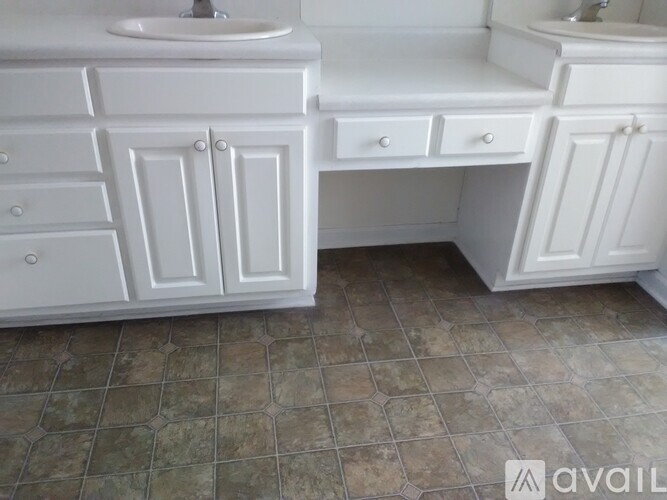 A bathroom with two sinks and a countertop.