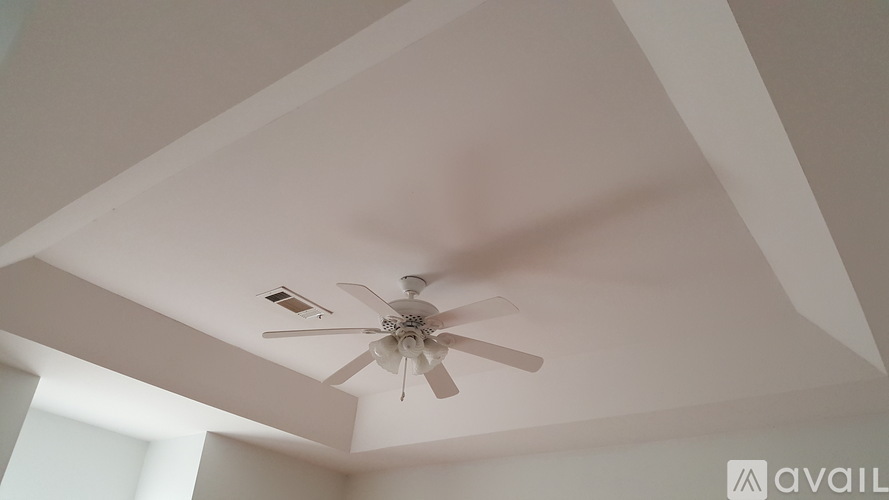 A ceiling fan is mounted on a white ceiling.