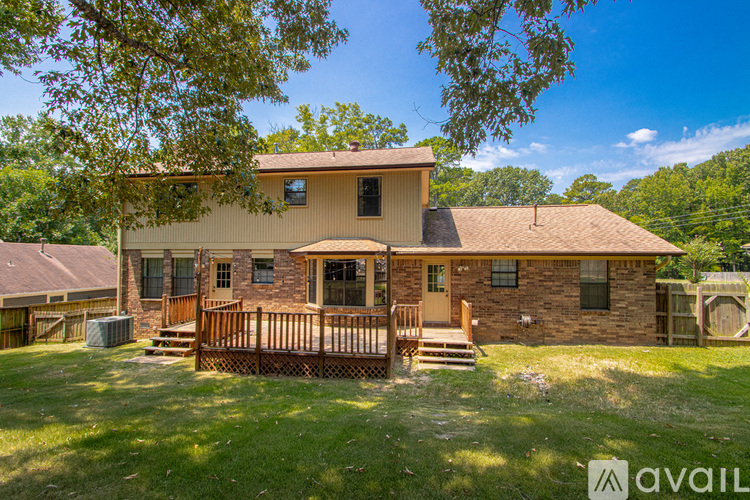 A house with a brown roof and a wooden fence in front.