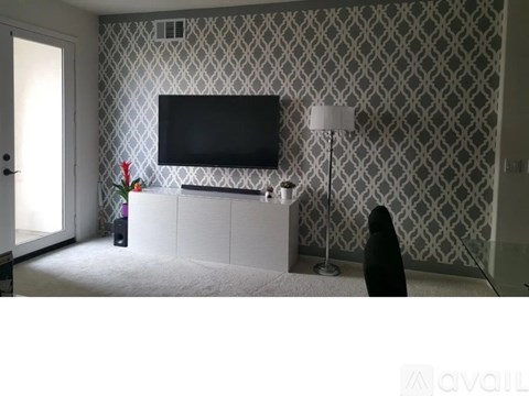 A living room with a television and a lamp.