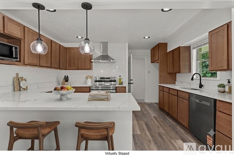 A kitchen with brown cabinets and white countertops.