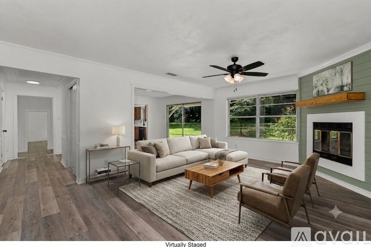 A living room with a white couch and a wooden coffee table.