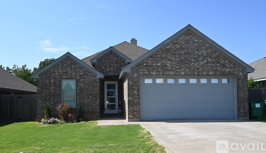 A house with a grey garage door is for sale.