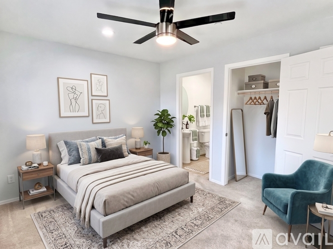 A bedroom with a large bed and a ceiling fan.