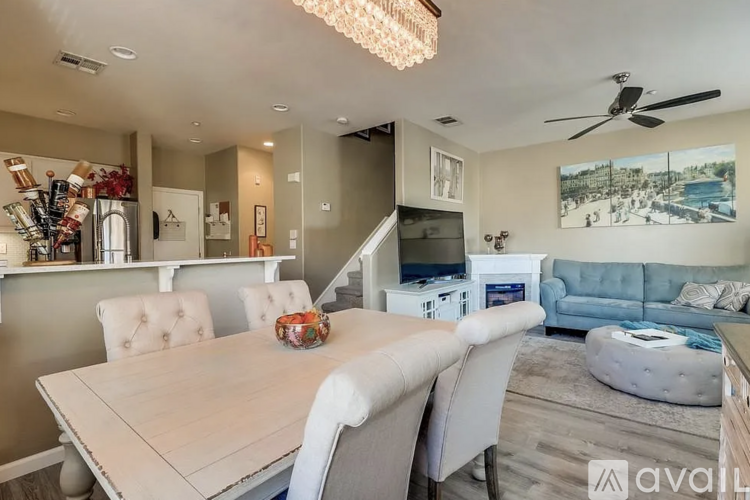 A modern dining room with a wooden table and chairs.