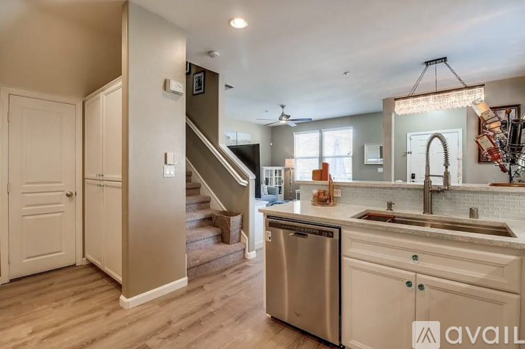 A kitchen with a stainless steel dishwasher and a sink.