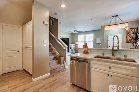 A kitchen with a stainless steel dishwasher and a sink.